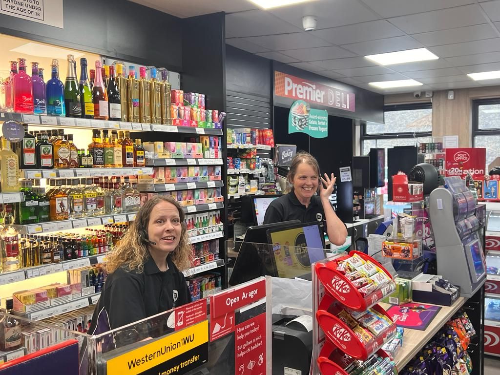 Shop workers behind counter wearing Wildix headphones