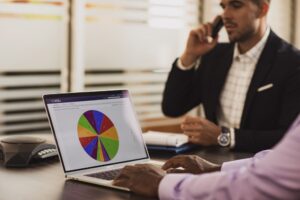 Business people on laptop and phone using Wildix software